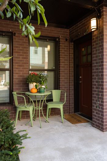 A table with two chairs is set outside on a patio.
